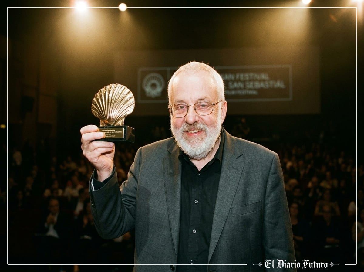 Mike Leigh sostiene la Concha de Oro en el escenario del Kursaal